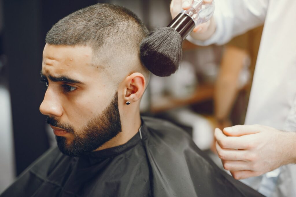 man cuts his beard barbershop discovering what is a fade haircut