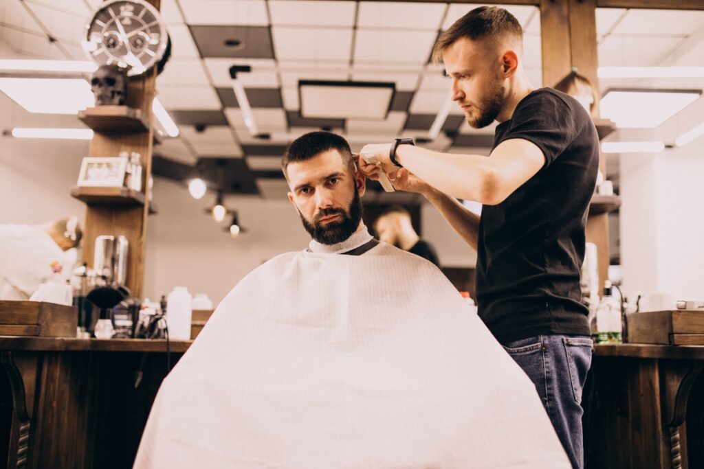man barbershop salon doing haircut beard trim saying how much for a haircut
