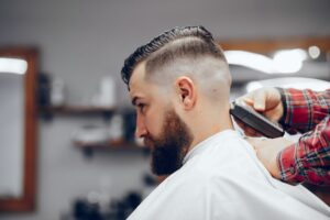 Elegant man sitting in a barbershop listening to advice on finding the perfect haircut